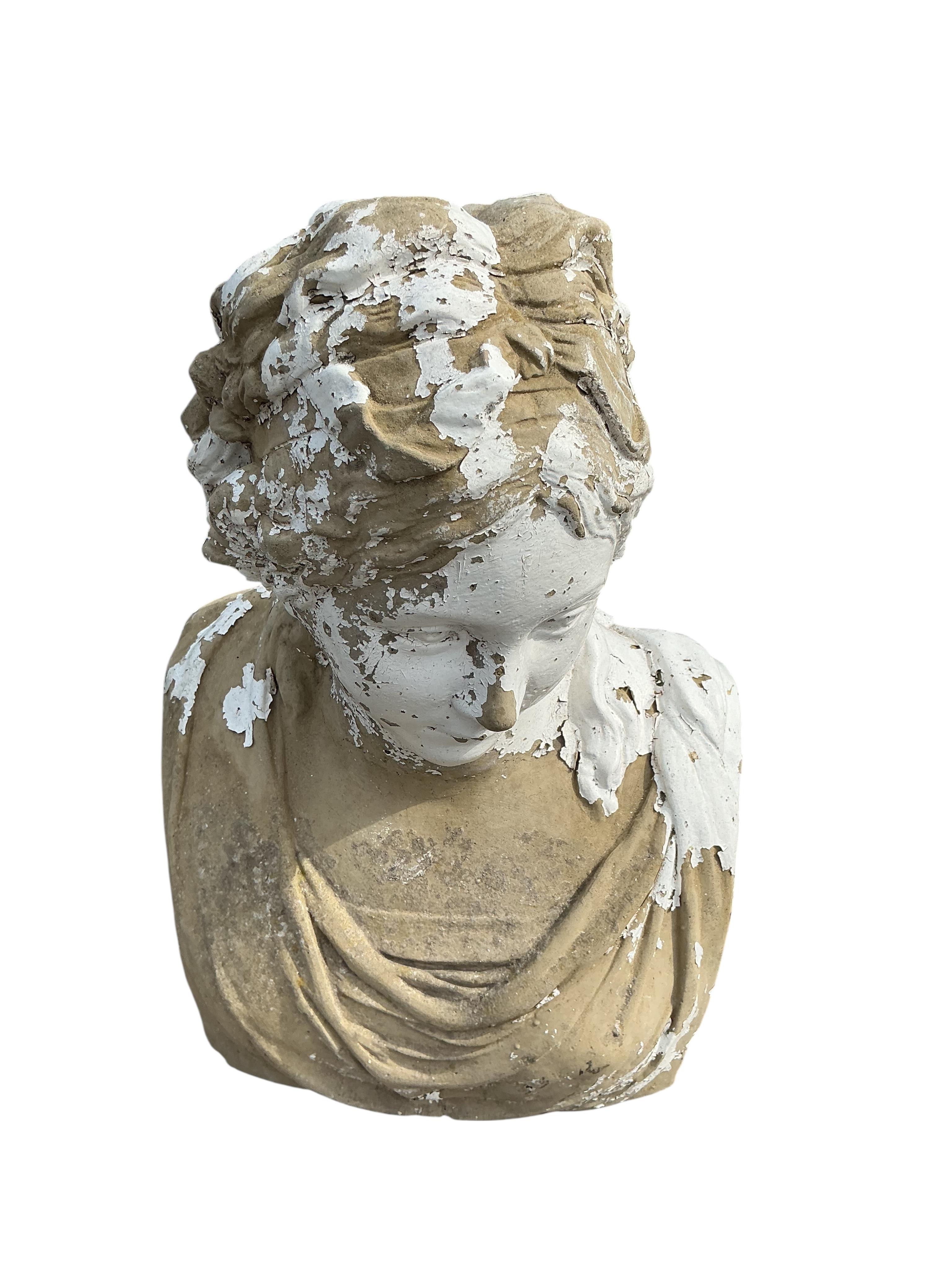 A painted stone garden bust of a female on associated square pedestal, combined height 80cm
